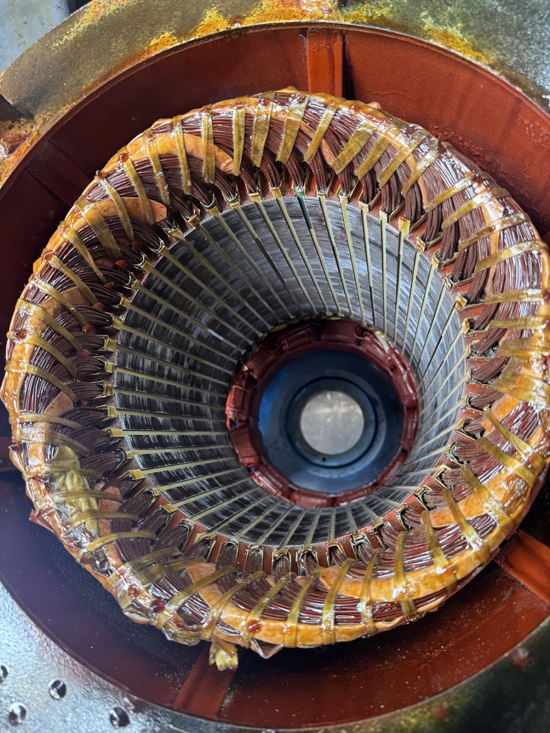 Electric motor repair technician rewinding industrial motor stator